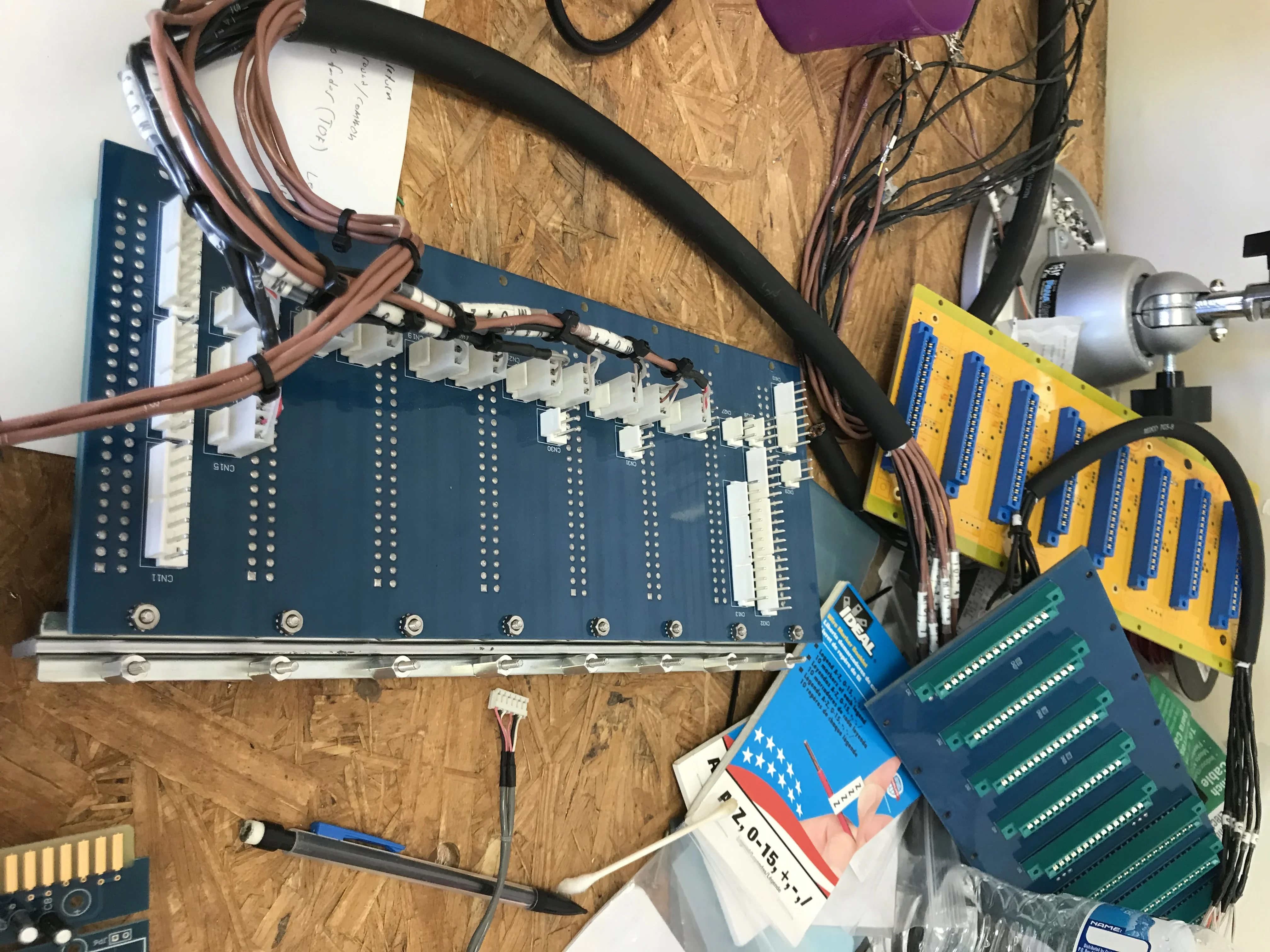 Bus board with connectors and cable harnesses on a workbench