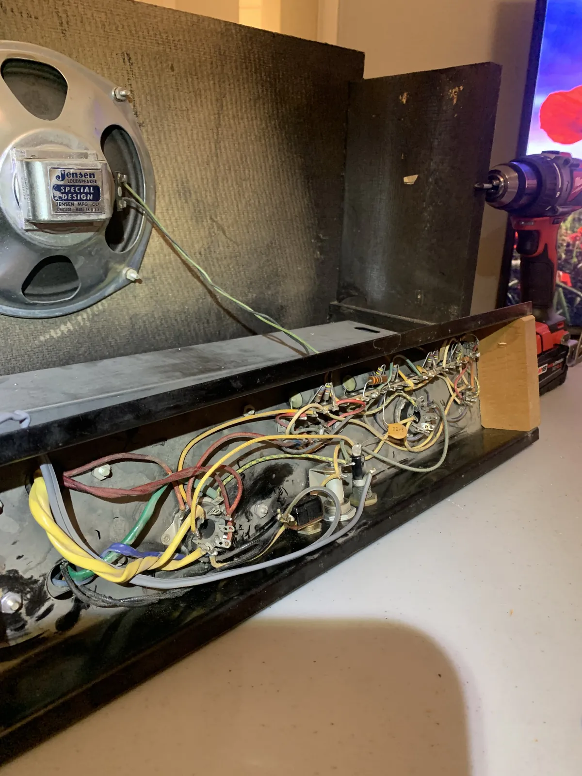 Chassis pulled with point-to-point wiring visible next to the speaker